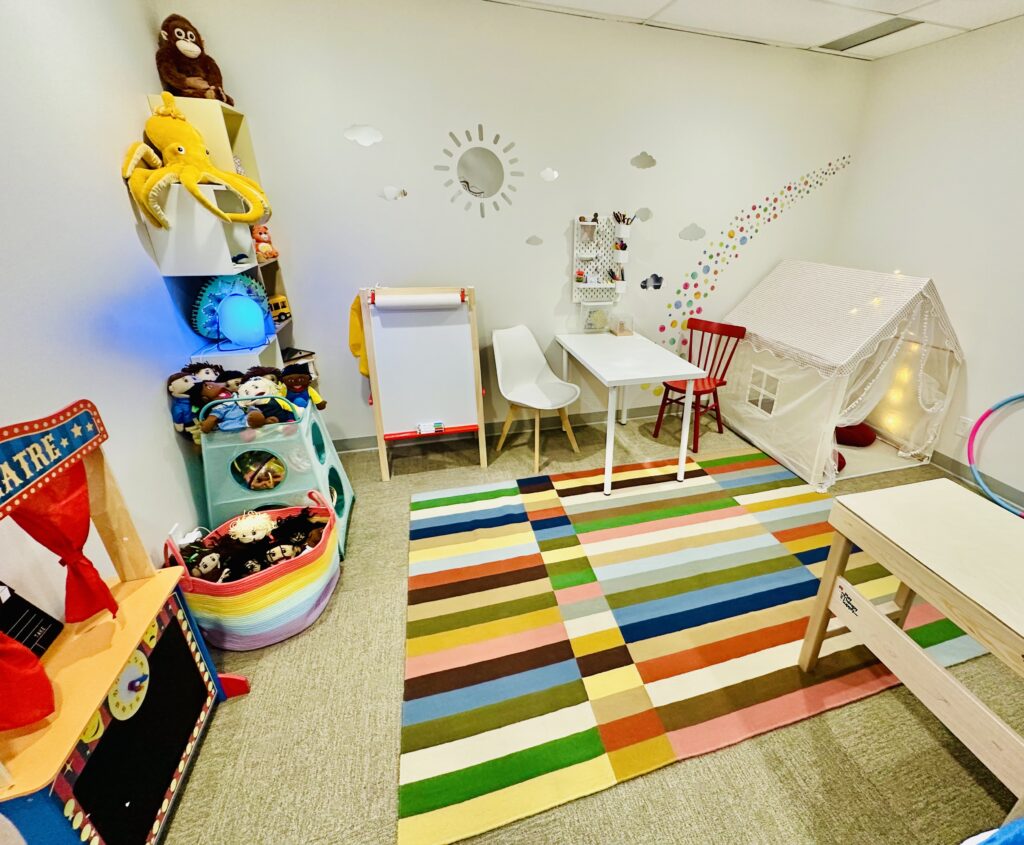 Child painting during play therapy session in Calgary