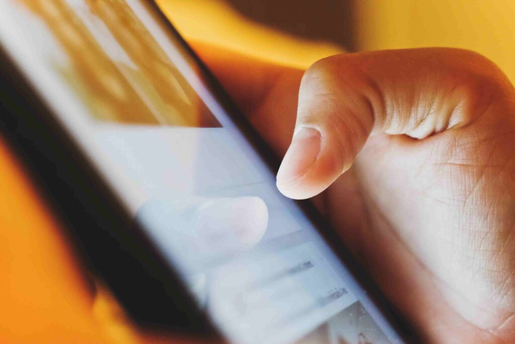 Person doomscrolling through negative news on a smartphone