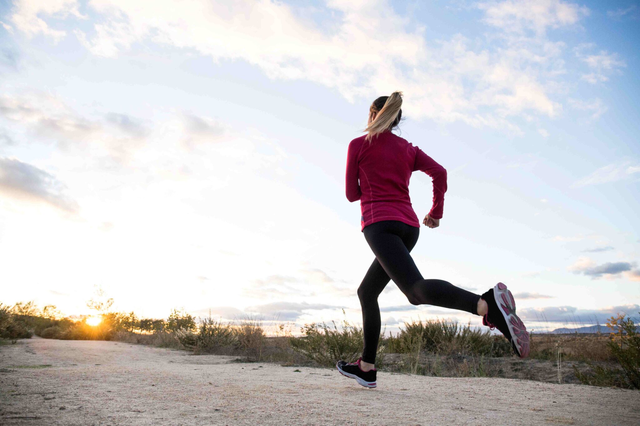 Woman running outdoors as part of a healthy self-care routine