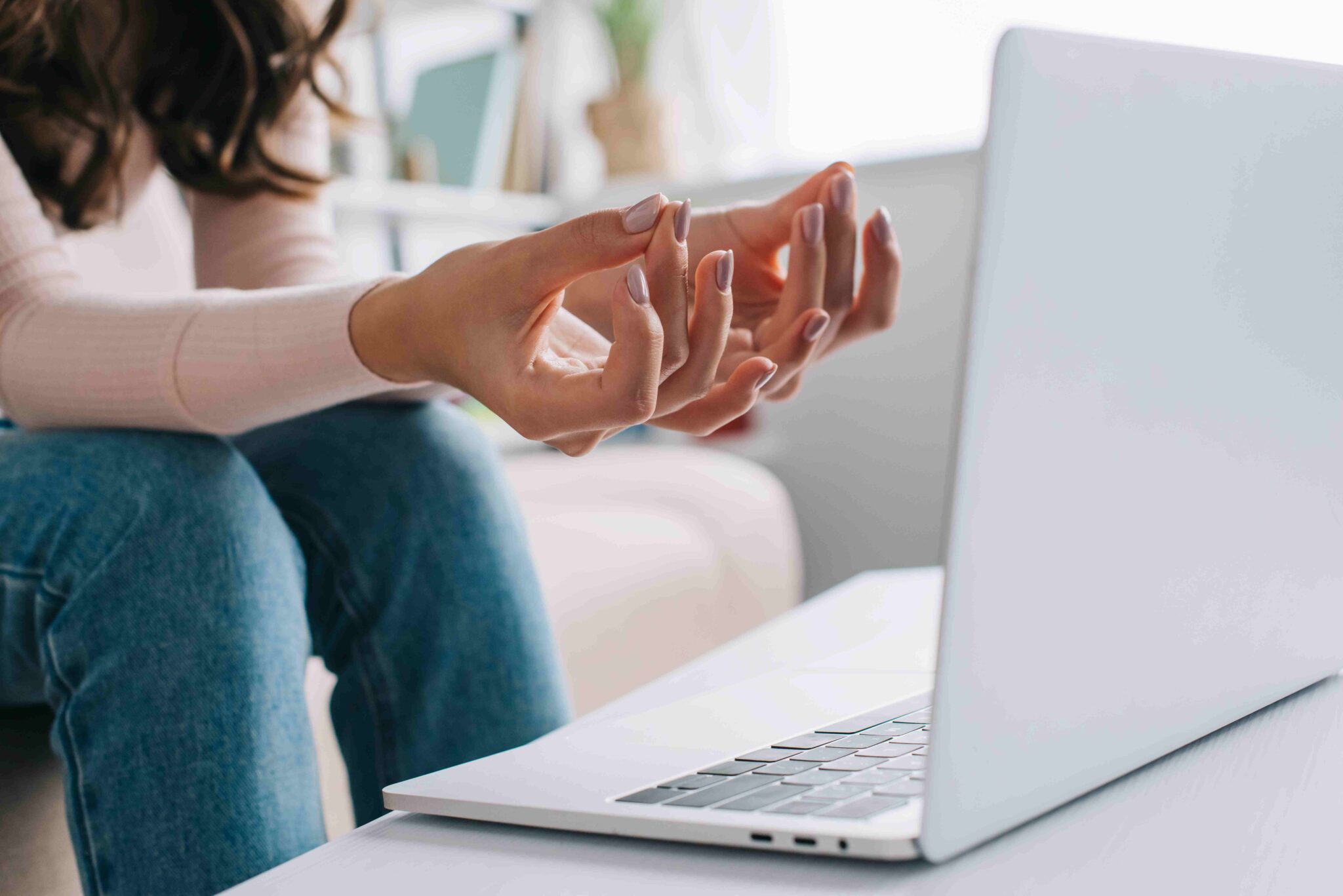 Woman attending an online counselling session from home